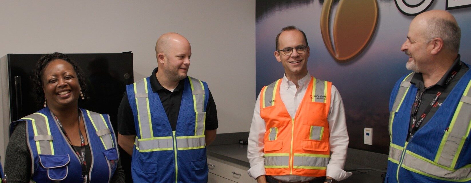 Brien Downie, CEO of Holman Logistics with three team members.